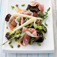 Elegant Parma ham and pistachio salad topped with white chocolate curls