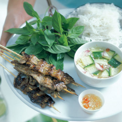 Grilled lemon grass beef skewers with lettuce, herbs and dips