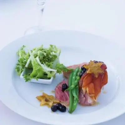 Cranberry and apple glazed gammon topped with caramelised apple and blueberries, and served with crisp greens