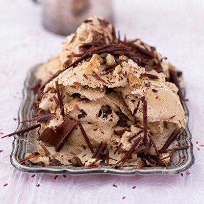 Espresso icecream sundae with crushed nuts and chocolate curls