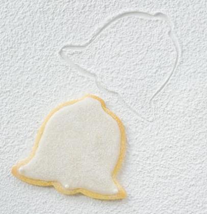 Festive icing-enrobed allspice biscuit bells | Woolworths TASTE