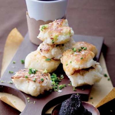 Fluffy potato cakes with black caviar
