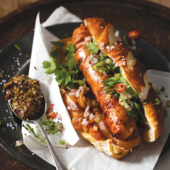 Gourmet hot dog with red onion, chilli and coriander salsa