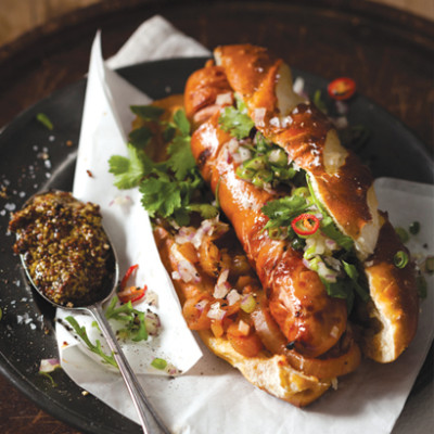 Gourmet hot dog with red onion, chilli and coriander salsa