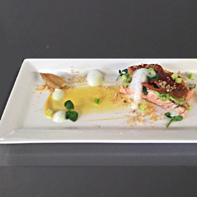 Jasmine oil-poached salmon with pea puree, pickled cucumber, crisp prosciutto and passion fruit sauce