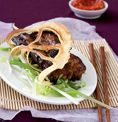 Lace pancakes stuffed with sticky soy ribs served with spring-onion curls | Woolworths TASTE