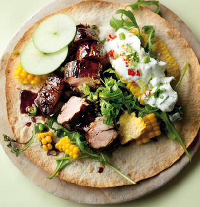 Oven-crisped tortillas topped with pomegranate pork fillet | Woolworths TASTE