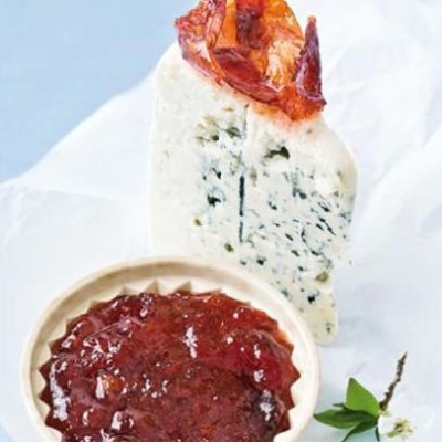 Plum paste served with a wedge of creamy gorgonzola