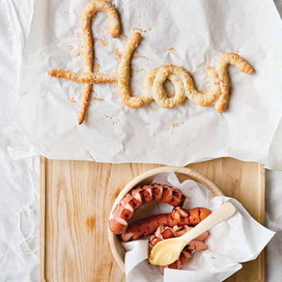Pretzel letters with bratwurst and mustard