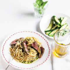 Rare grilled venison steaks with basil oil on pasta