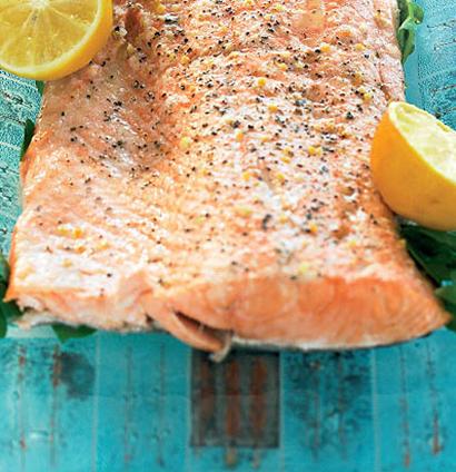 Roast citrus-salted salmon and lemons served with baked potato in cream | Woolworths TASTE