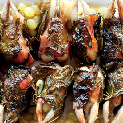 Roast quail wrapped in vine leaves with grapes and herbed orzo