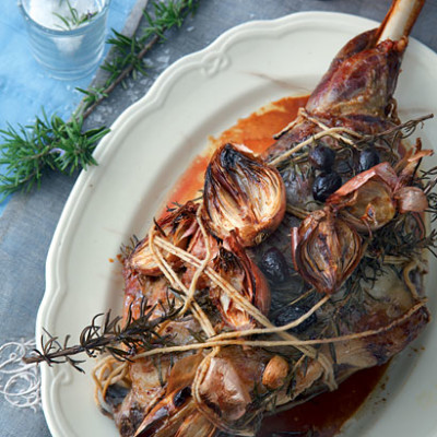 Rosemary and garlic leg of lamb with caramelised shallots and black olives