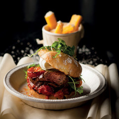 Seared beef fillet burger with roast tomatoes, buffalo mozzarella and polenta chips