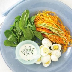 Shredded organic raw vegetables with baby spinach and hard-boiled organic eggs