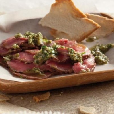Slivers of beef carpaccio with a zesty caper dressing and melba toasts