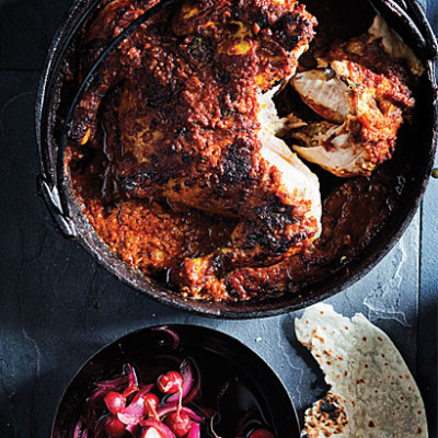 Spatchcock chicken in a tomato vindaloo potjie with radish pickle