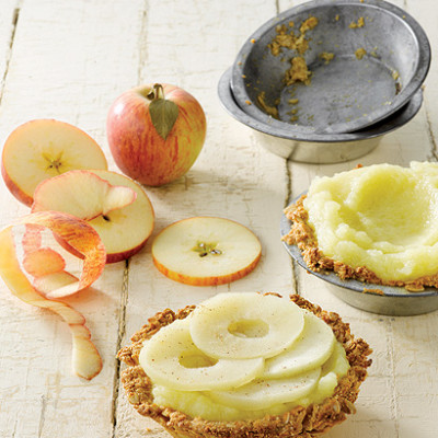 Spiced puree apple tarts with oat crust topped with slow poached apples
