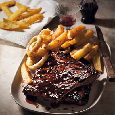 Sticky barbecue pork spareribs with chunky triple-cooked chips and crispy onion rings