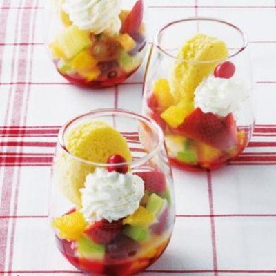 Strawberry fruit salad cups with fresh Madeira cake and a drizzle of strawberry syrup