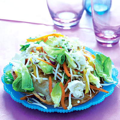 Tostada with salad, cheese and chilli dressing