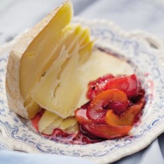Verjuice-poached stone fruit with a wedge of cheese