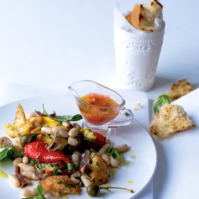 White bean panzanella salad with tomato dressing, caperberries and anchovies