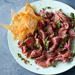 Beef carpaccio with coriander, chilli and lime pesto and phyllo sesame chips