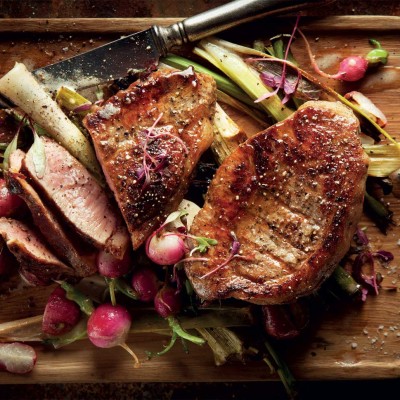 Thyme-roasted baby leeks and radishes with free-range chargrilled steaks