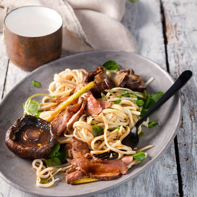Roast marinated steak with mushrooms and green noodles