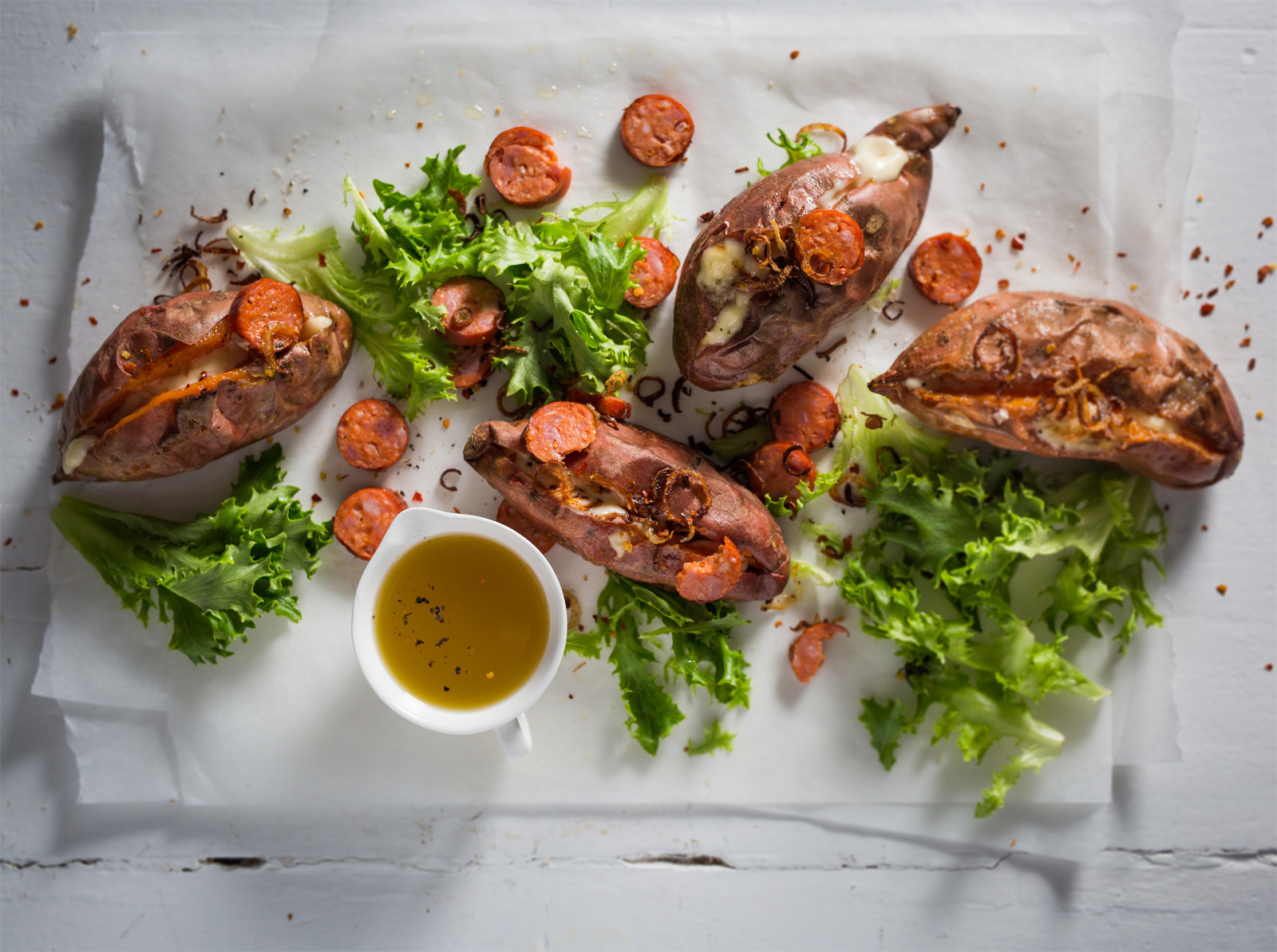 Twicebaked sweet potatoes with spicy sausage, bitter greens and crispy