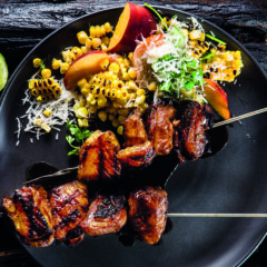 Maple-and-balsamic duck skewers with charred corn salad