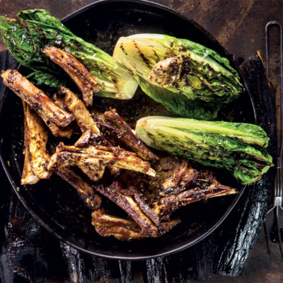 Lamb ribbetjies with black garlic butter and charred lettuce