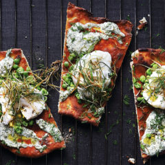 Poached egg pizza with smashed peas, charred leeks and dill mayo