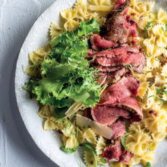 Seared beef carpaccio on lemon-oil and anchovy-dressed pasta with parmesan and greens
