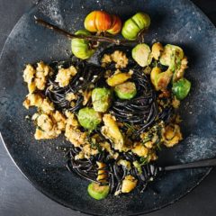 Cuttlefish-ink spaghetti with green olive sourdough sauce and Brussels sprouts
