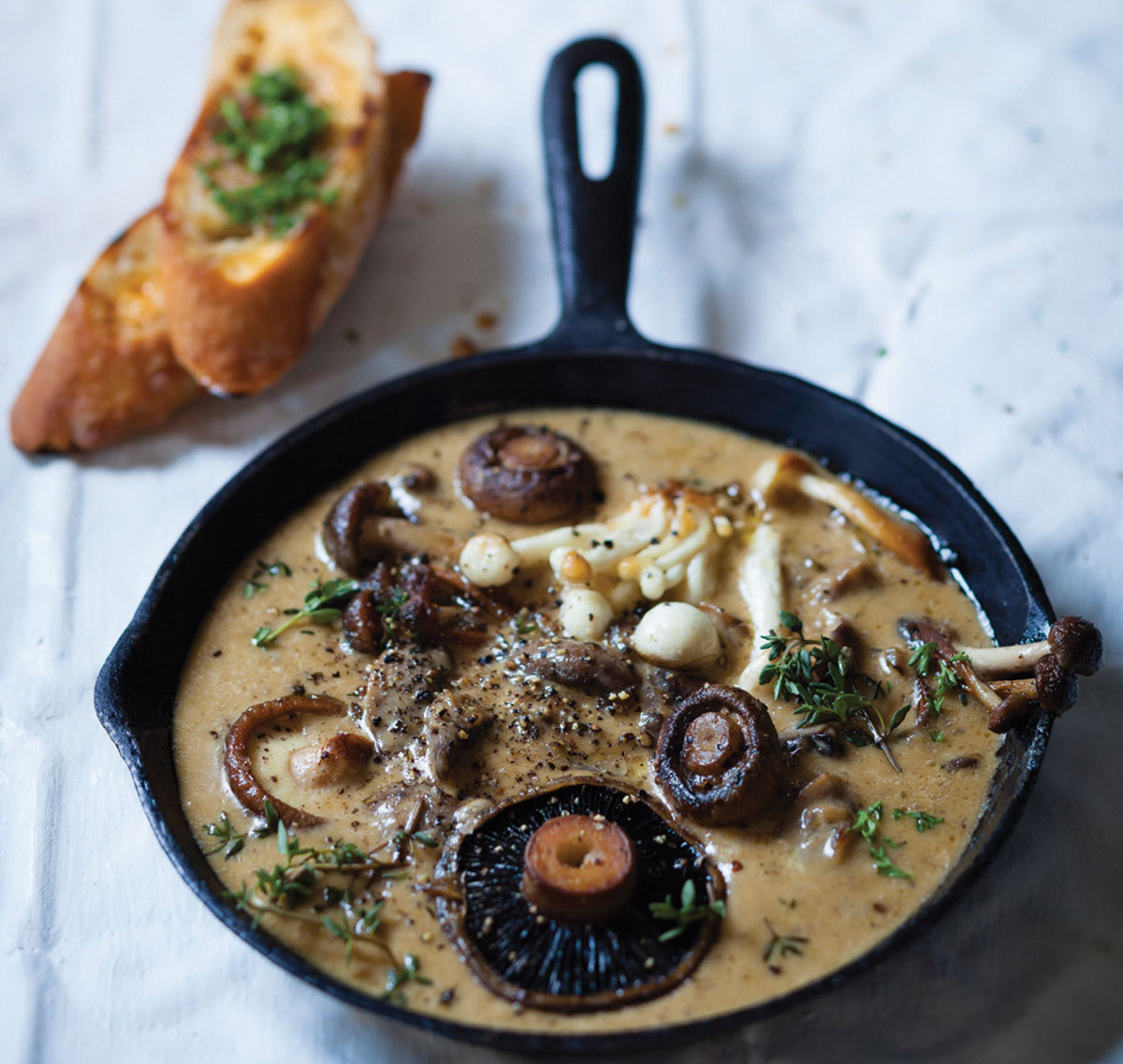 Mushrooms with roasted garlic cream and herb-buttered toast