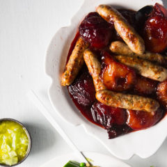 Duck sausages with vino cotto-poached plums