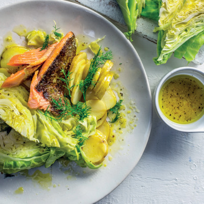 Steamed cabbage wedges and trout with lemon and dill
