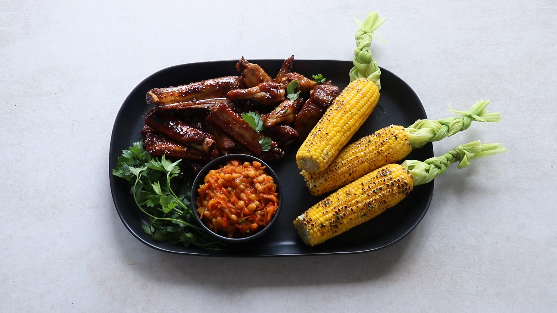 The Lazy Makoti’s sticky ribs, chakalaka and plaited corn Woolworths