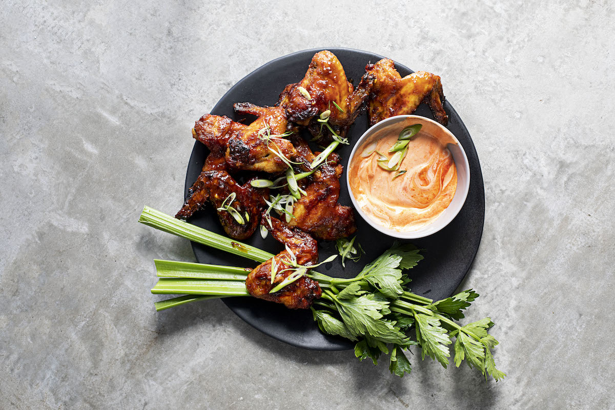 Abi’s ultimate sticky-spicy chicken wings with sour cream-and-sriracha dip | Woolworths TASTE