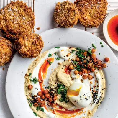 Soft-boiled Turkish-style eggs with hummus, labneh, crumbed brinjal and paprika oil