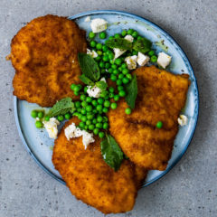 Chicken schnitzels with frozen peas, feta and mint