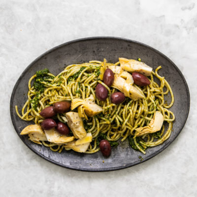 Spaghetti with basil pesto, olives and artichokes