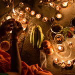 Close up hand lighing Diwali lamps