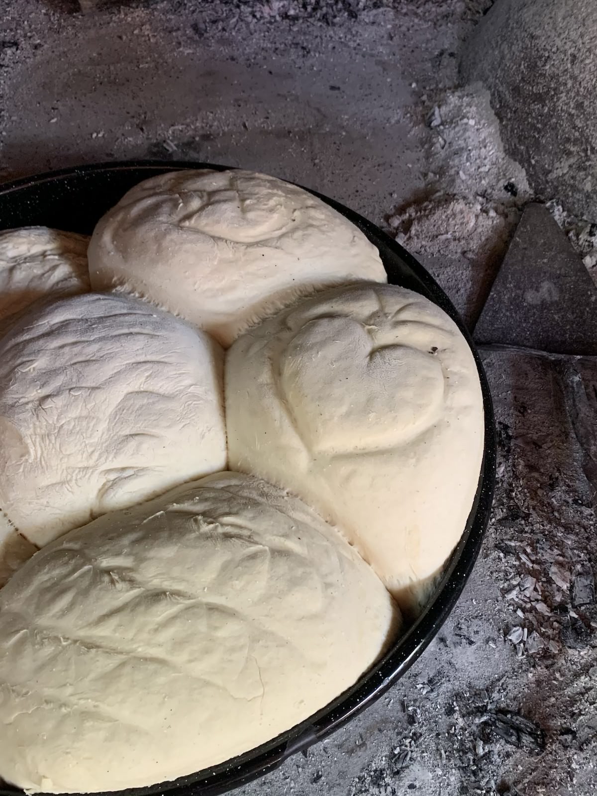 freshly baked bread made under the peka
