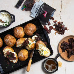 Braaied baked potatoes stuffed with sour cream and biltong