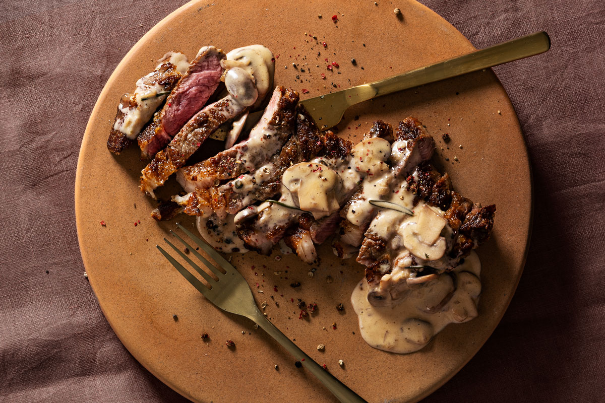 Pink roasted steak with mushroom-and-pepper sauce