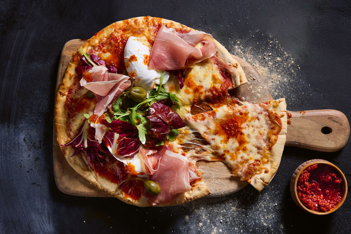 Pizza with nduja paste, prosciutto and buffalo mozzarella