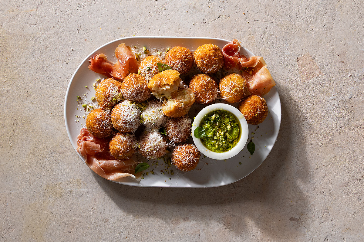 Grana Padano arancini with pistachio pesto and prosciutto | Woolworths TASTE